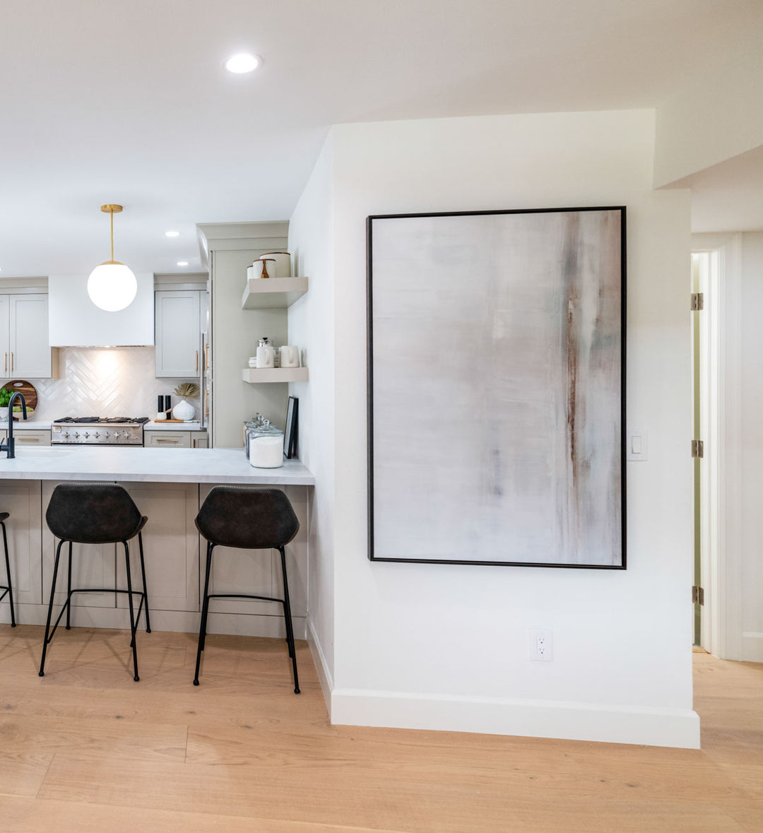 After the Storm framed in ebony creates an impactful focal wall for the transitional space between the living area and dining